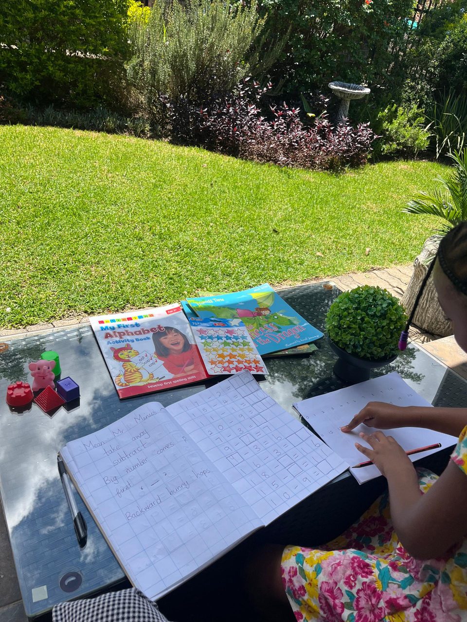 A child doing maths in the garden